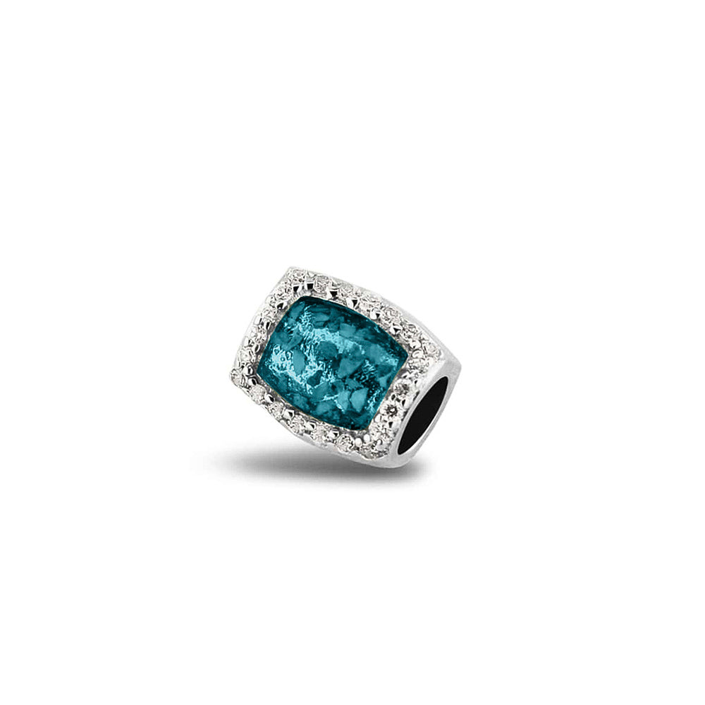 Asbedel rondom afgewerkt met zirkonia's die aan beide zijdes in twee compartimenten zichtbaar gevuld wordt met as of haar. Turquoise