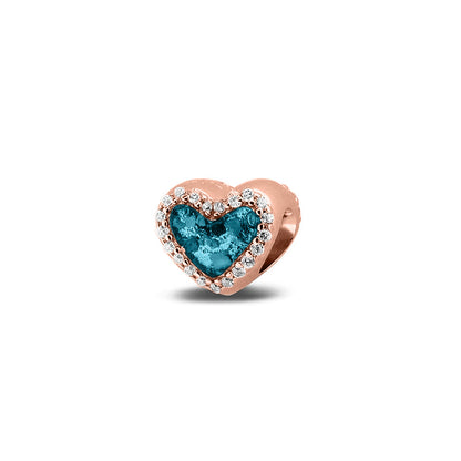 Hartvormige asbedel met  zirkonia's rondom afgewerkt, die aan beide zijdes in twee compartimenten zichtbaar gevuld wordt met as of haar met een keuze in 20 kleuren. Turquoise