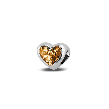 Hartvormige asbedel, aan beide zijdes zichtbaar gevuld met as of haar. Het vullen en sealen met onze speciale hars met een keuze in 20 kleuren, wordt in onze ambachtelijke edelsmederij gedaan. Gold