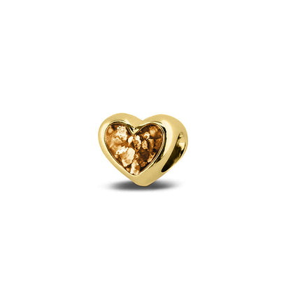Hartvormige asbedel, aan beide zijdes zichtbaar gevuld met as of haar. Het vullen en sealen met onze speciale hars met een keuze in 20 kleuren, wordt in onze ambachtelijke edelsmederij gedaan. Gold