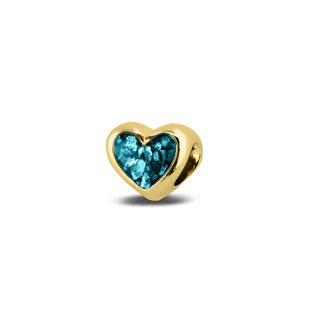 Hartvormige asbedel, aan beide zijdes zichtbaar gevuld met as of haar. Het vullen en sealen met onze speciale hars met een keuze in 20 kleuren, wordt in onze ambachtelijke edelsmederij gedaan. Turquoise