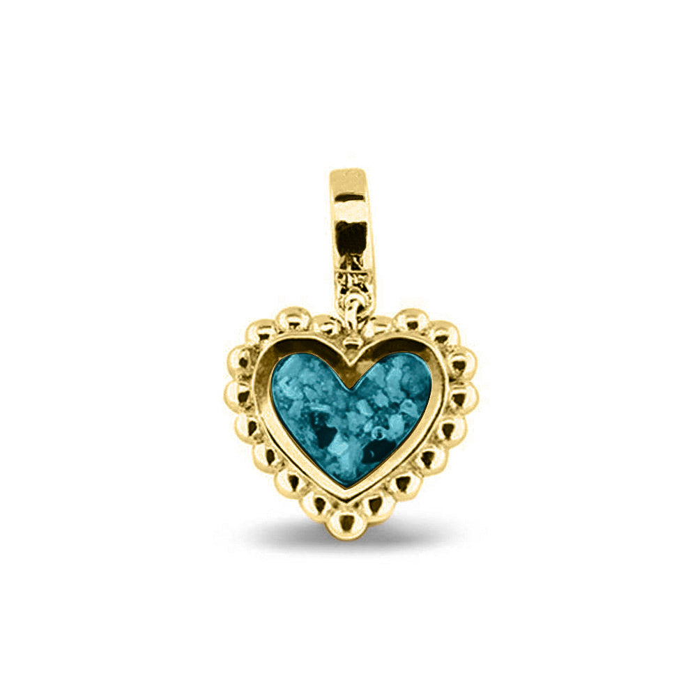 Hartvormige asbedel, die aan de voorzijde zichtbaar gevuld wordt met as of haar. Het vullen en sealen met een keuze in 20 kleuren, wordt in onze ambachtelijke edelsmederij gedaan. Turquoise