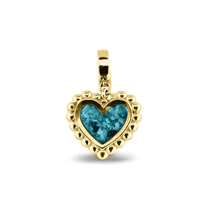 Hartvormige asbedel, die aan de voorzijde zichtbaar gevuld wordt met as of haar. Het vullen en sealen met een keuze in 20 kleuren, wordt in onze ambachtelijke edelsmederij gedaan. Turquoise