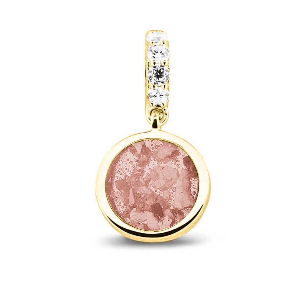 Asbedel rond subtiel design , het hangoog aan de buitenrand afgewerkt met zirkonia's, die aan de voorzijde zichtbaar gevuld wordt met as of haar met een keuze in 20 kleuren. Blush