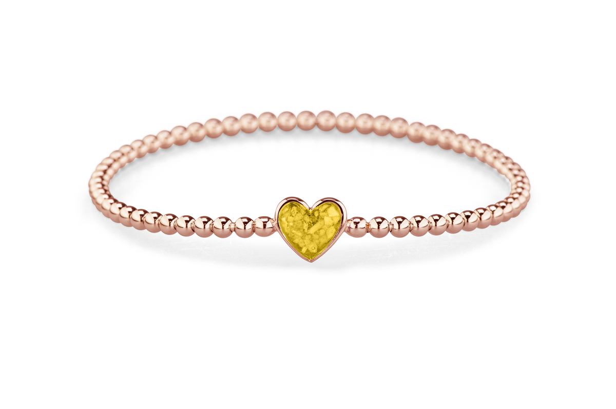 Flexibele as armband met hart als compartiment voor as of haar, gedenksieraden. Yellow