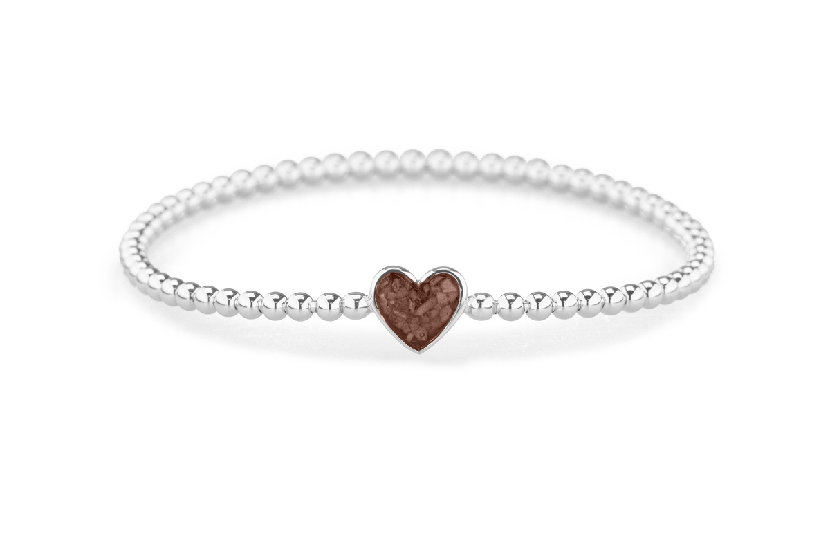Flexibele as armband met hart als compartiment voor as of haar, gedenksieraden. Brown
