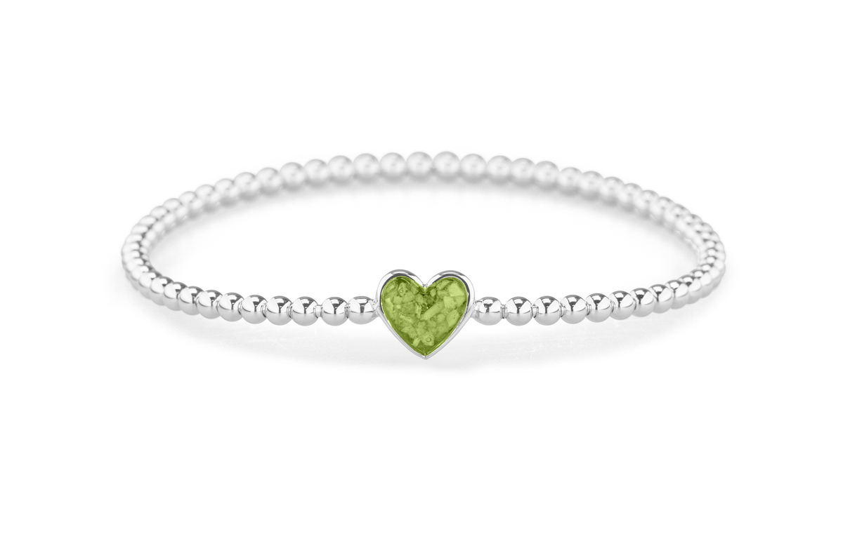 Flexibele as armband met hart als compartiment voor as of haar, gedenksieraden. Green