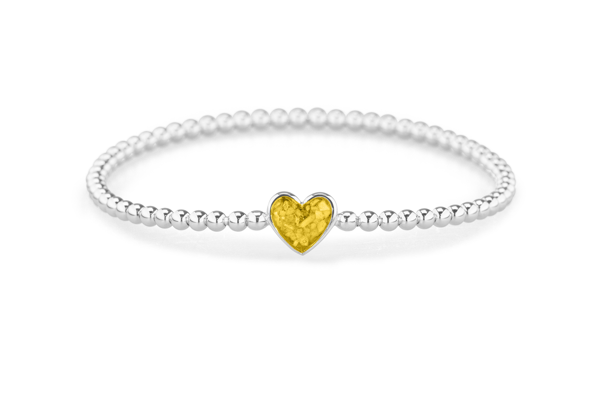 Flexibele as armband met hart als compartiment voor as of haar, gedenksieraden. Yellow
