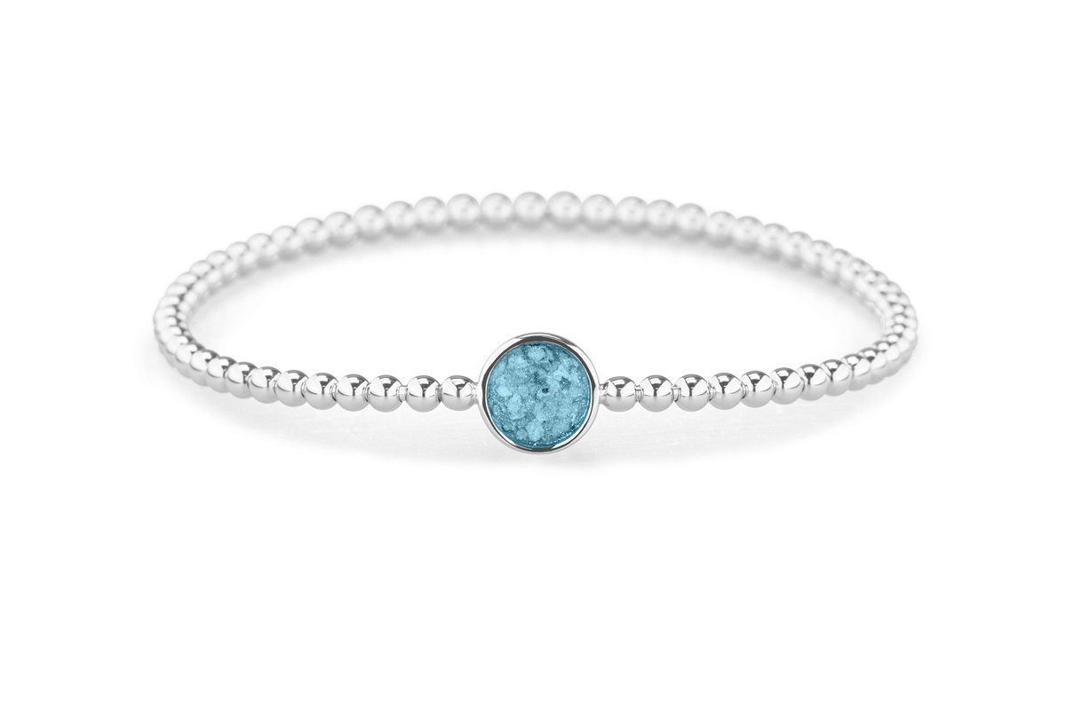 Flexibele as armband met rondje als compartiment voor as of haar, gedenksieraden. Baby