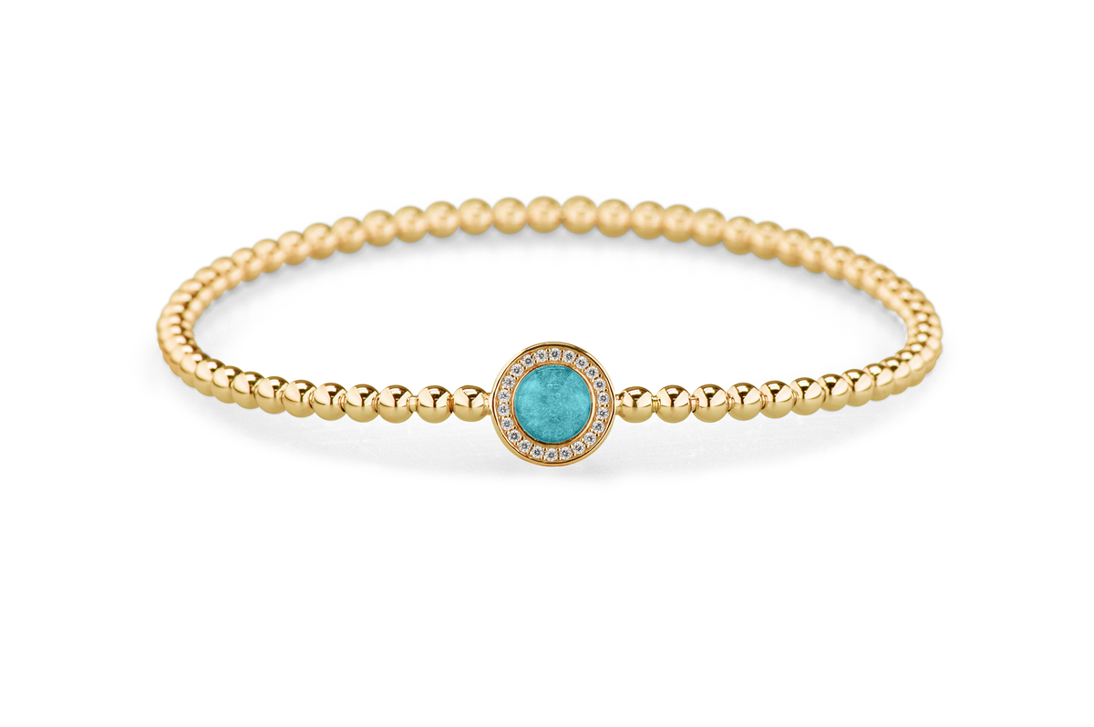 Flexibele as armband met rondje als compartiment gezet rondom met zirconia's voor as of haar. Aqua