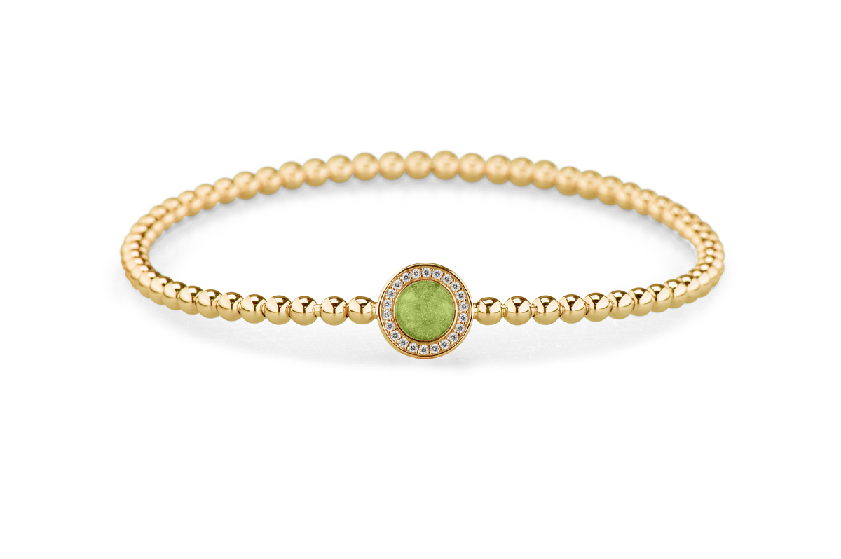 Flexibele as armband met rondje als compartiment gezet rondom met zirconia's voor as of haar. Green