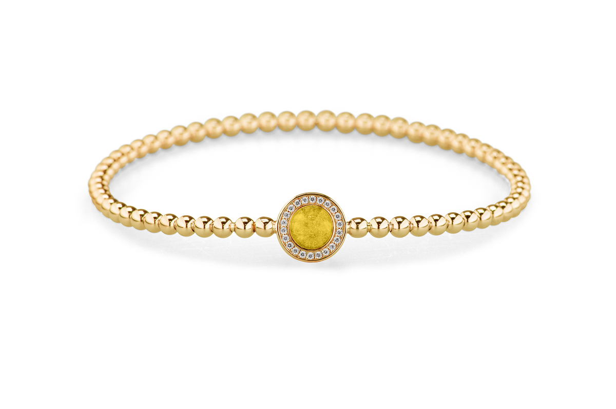 Flexibele as armband met rondje als compartiment gezet rondom met zirconia's voor as of haar. Yellow