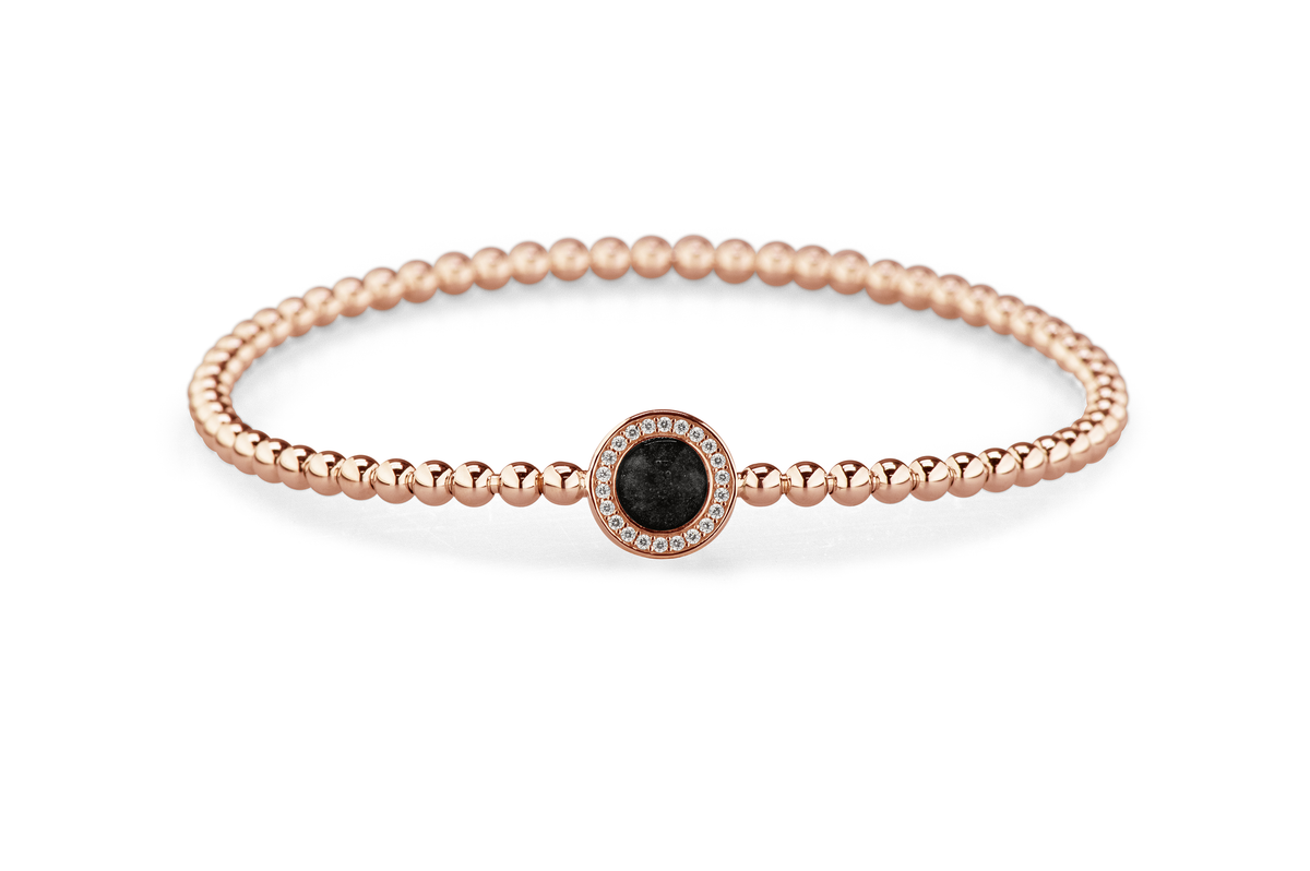 Flexibele as armband met rondje als compartiment gezet rondom met zirconia's voor as of haar. Black