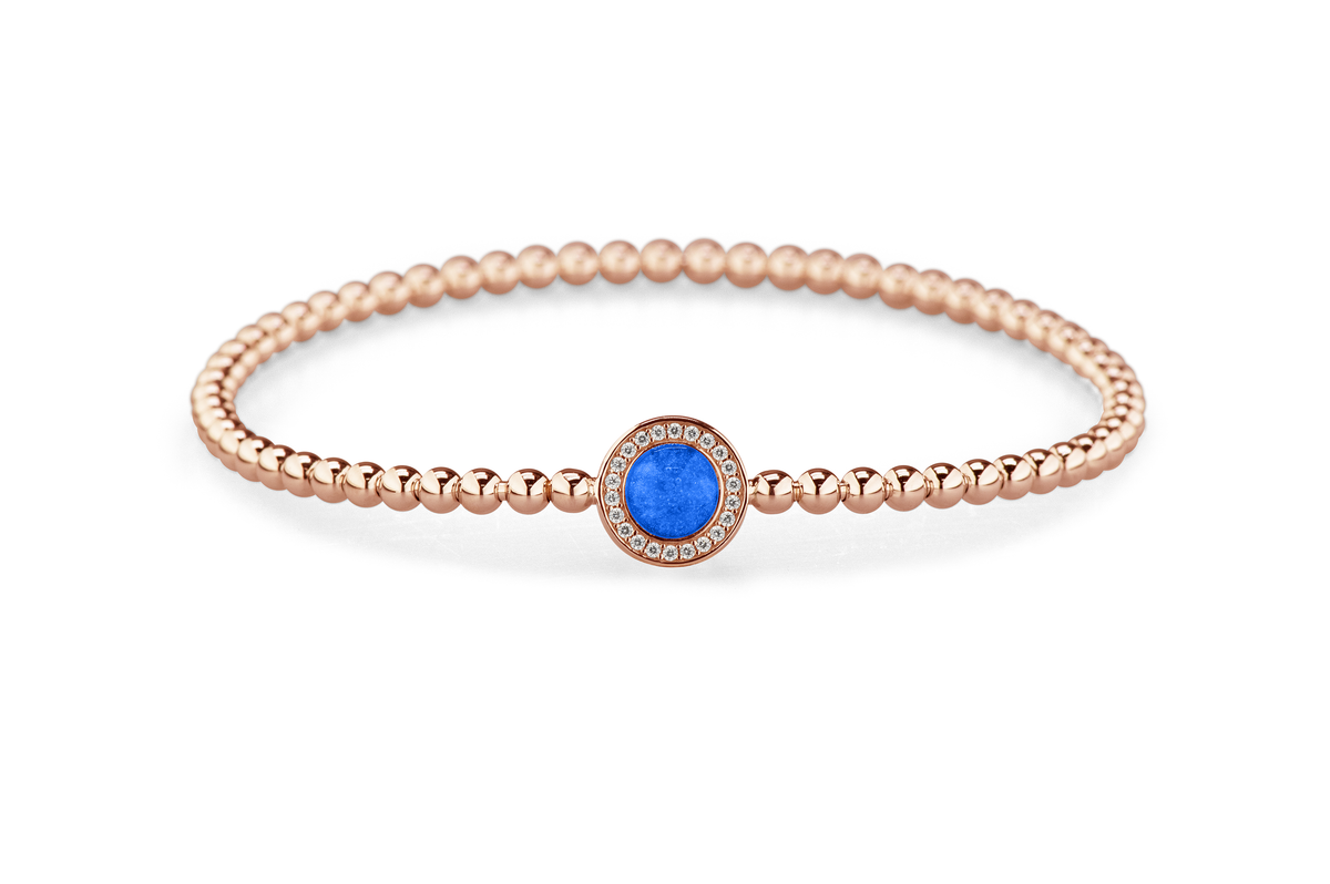 Flexibele as armband met rondje als compartiment gezet rondom met zirconia's voor as of haar. Blue