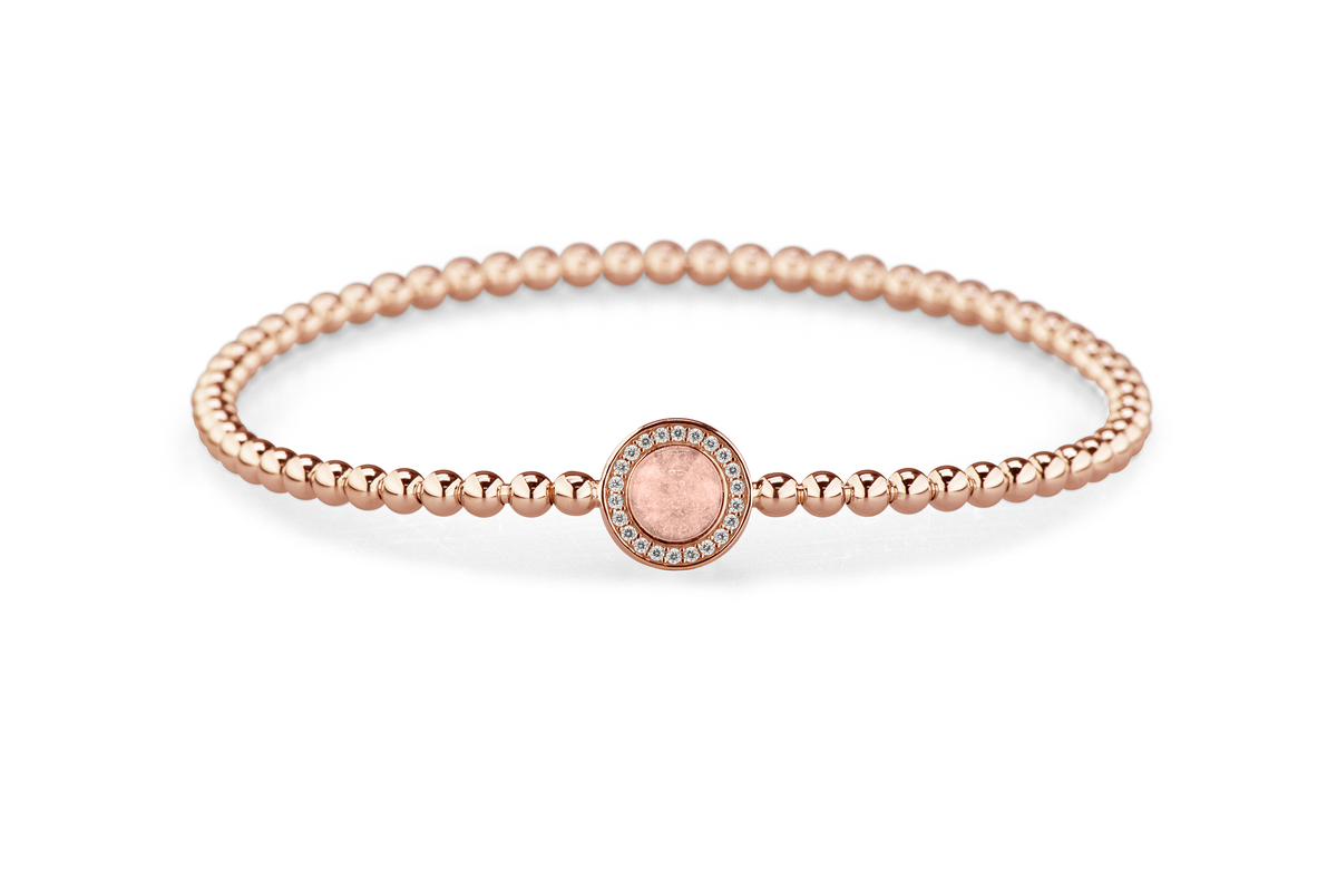 Flexibele as armband met rondje als compartiment gezet rondom met zirconia's voor as of haar. Blush
