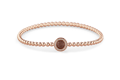 Flexibele as armband met rondje als compartiment gezet rondom met zirconia's voor as of haar. Brown