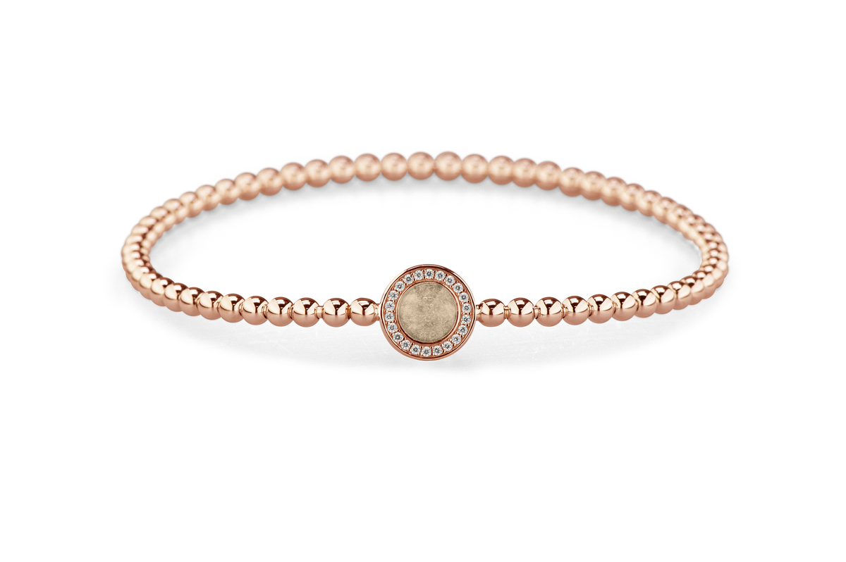 Flexibele as armband met rondje als compartiment gezet rondom met zirconia's voor as of haar. Transparent