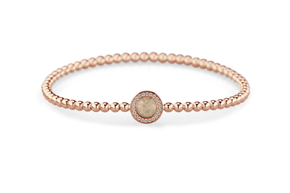 Flexibele as armband met rondje als compartiment gezet rondom met zirconia's voor as of haar. Transparent