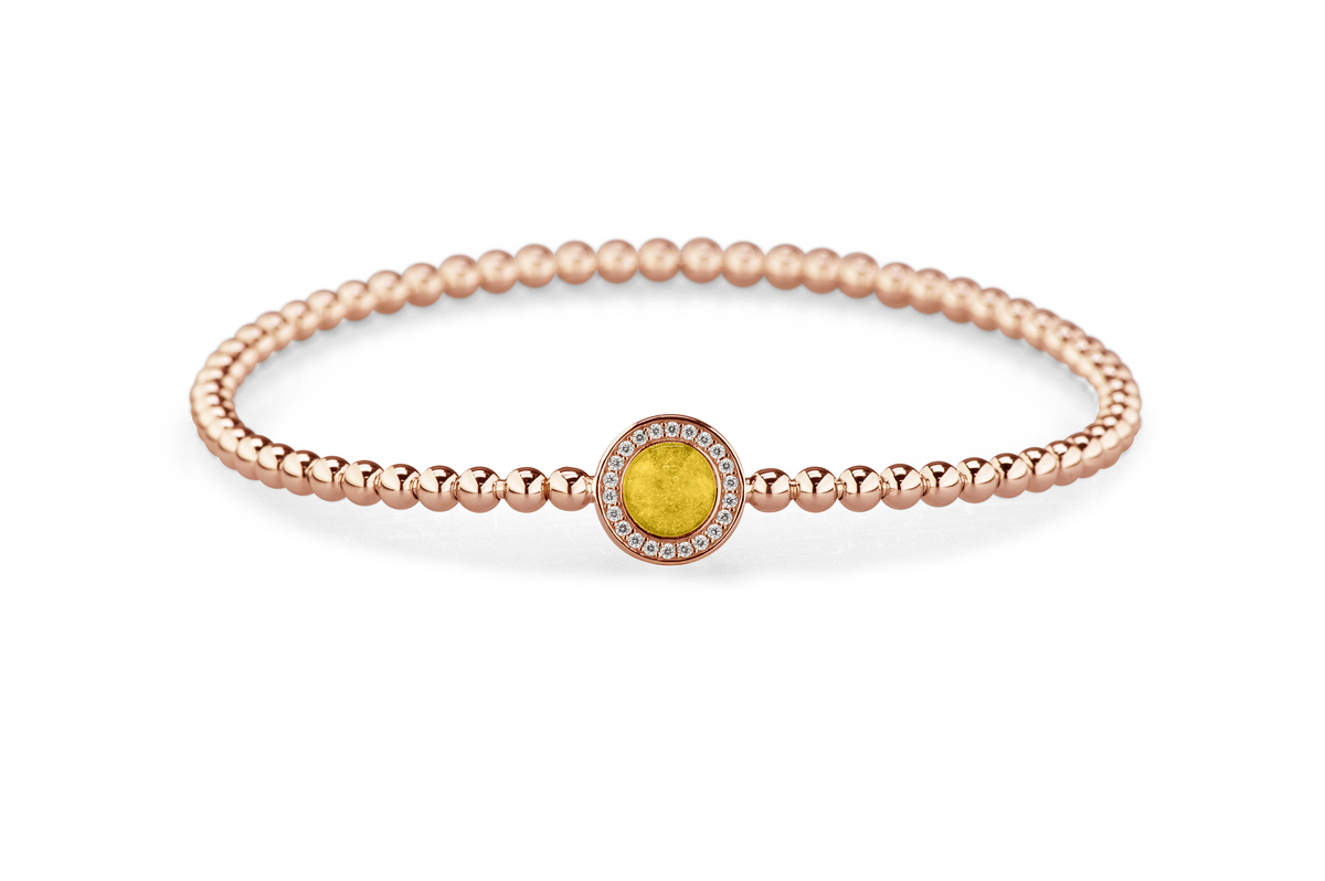 Flexibele as armband met rondje als compartiment gezet rondom met zirconia's voor as of haar. Yellow