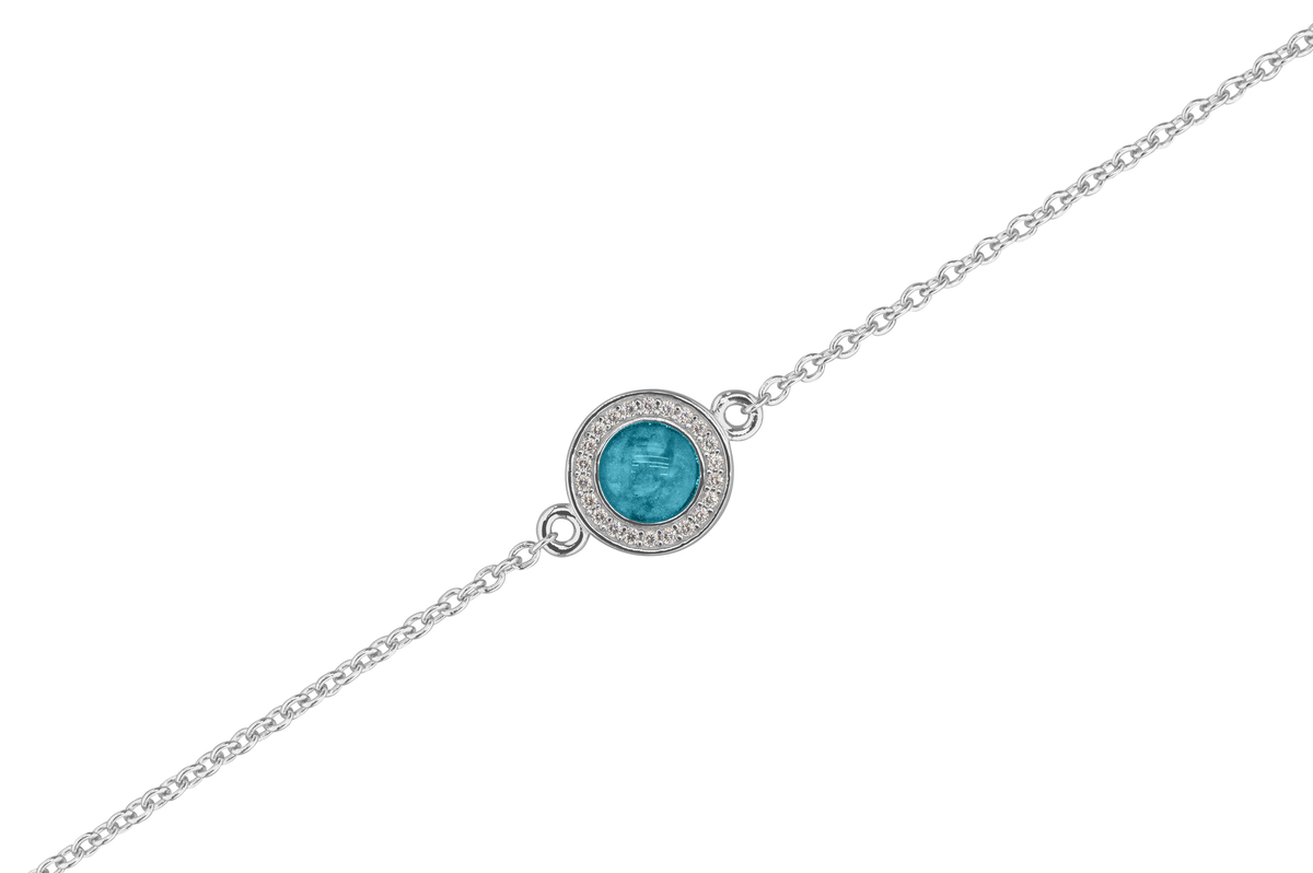 As armband met rondje als compartiment in het midden aan de voorzijde. Turquoise