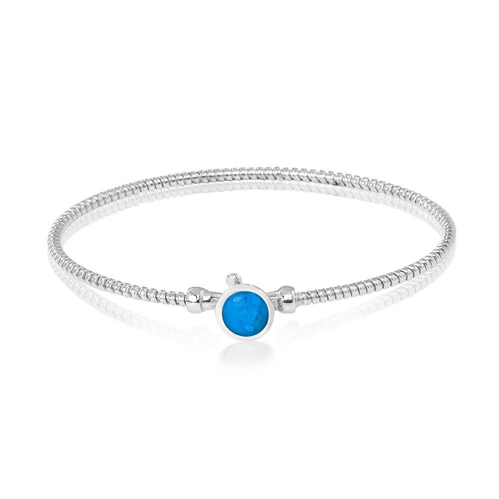 Zilveren as armband met in het midden een ornamentje, gedenksieraad. Marine