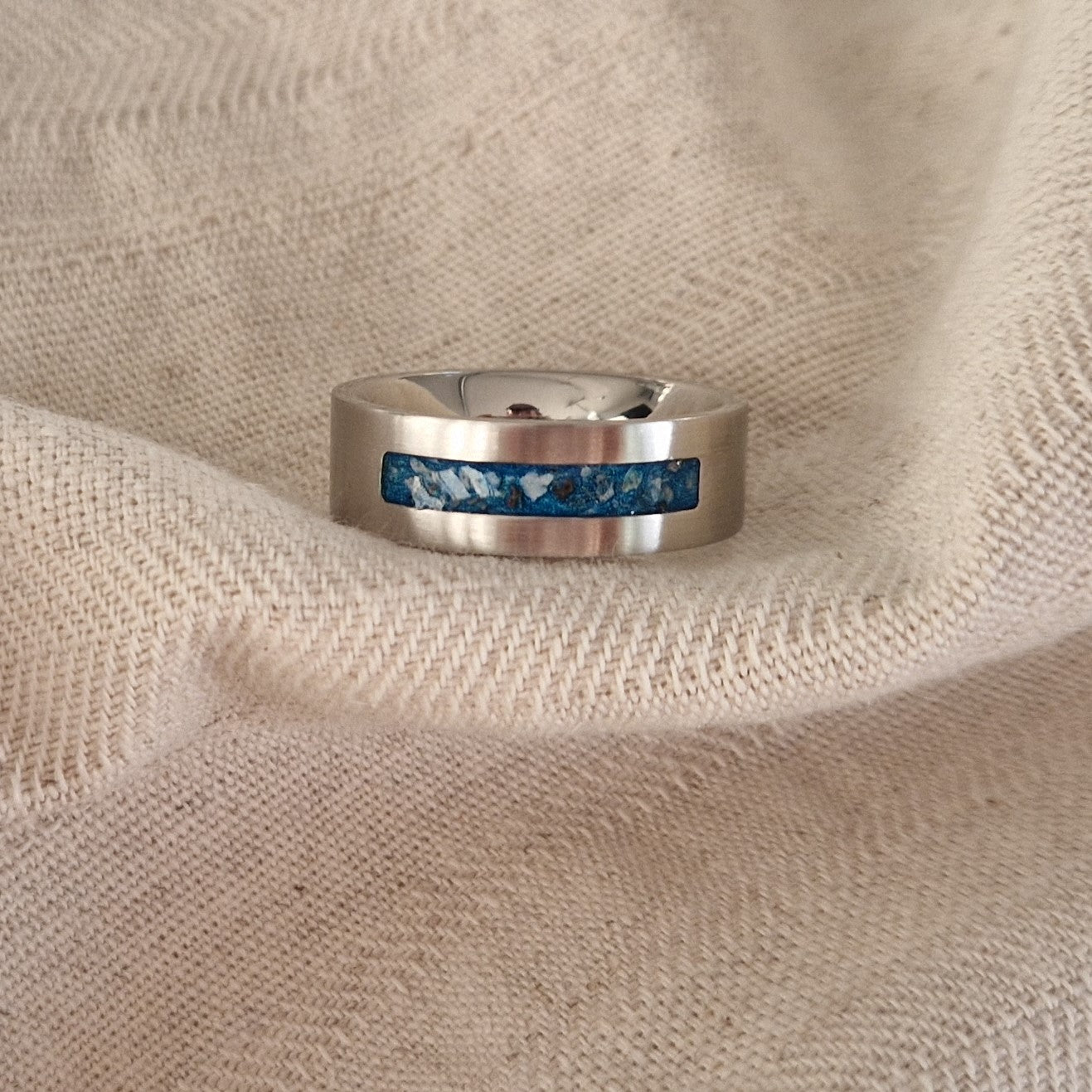 Ring als gedenksieraad 8 mm breed waar de ruimte aan de bovenzijde met as of haar verwerkt wordt. De asring is leverbaar in staal, zilver en in 14 en 18 KT geelgoud/witgoud en roségoud. Alle